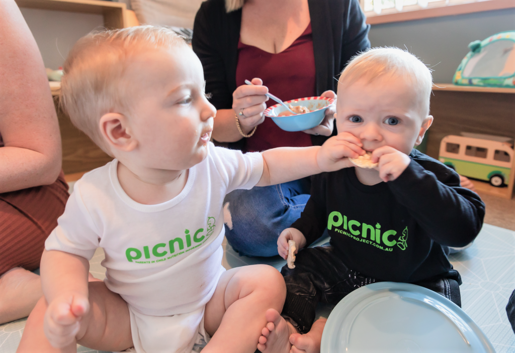 Boy taking cracker off another boy