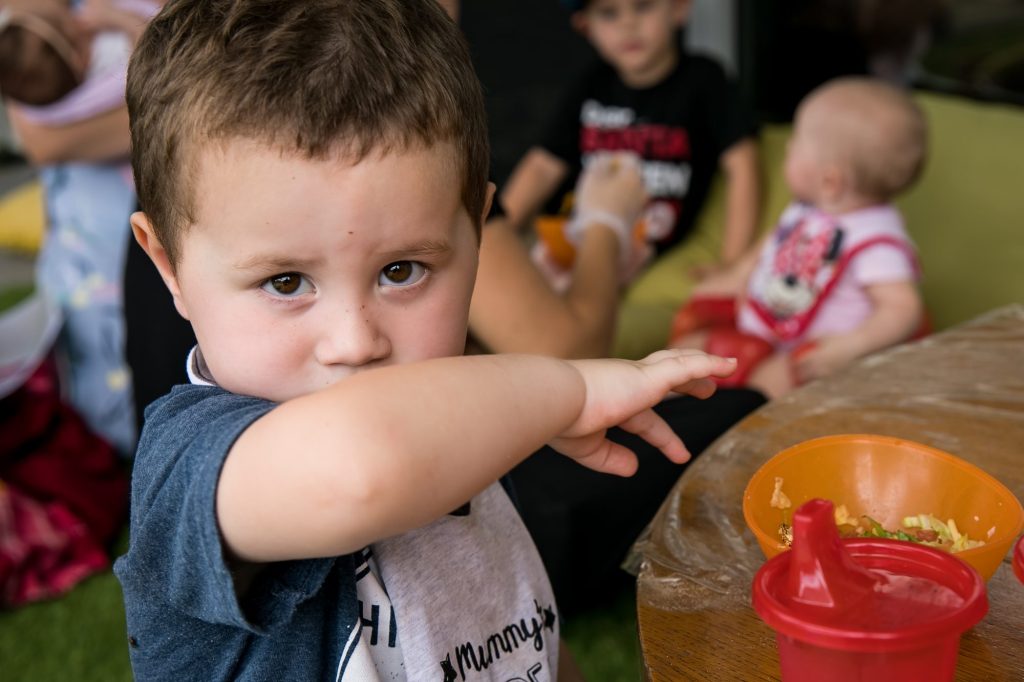 Child eating wiping mouth