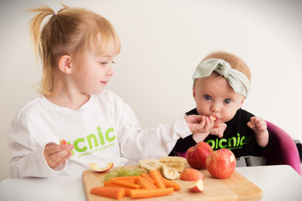 Child giving baby food