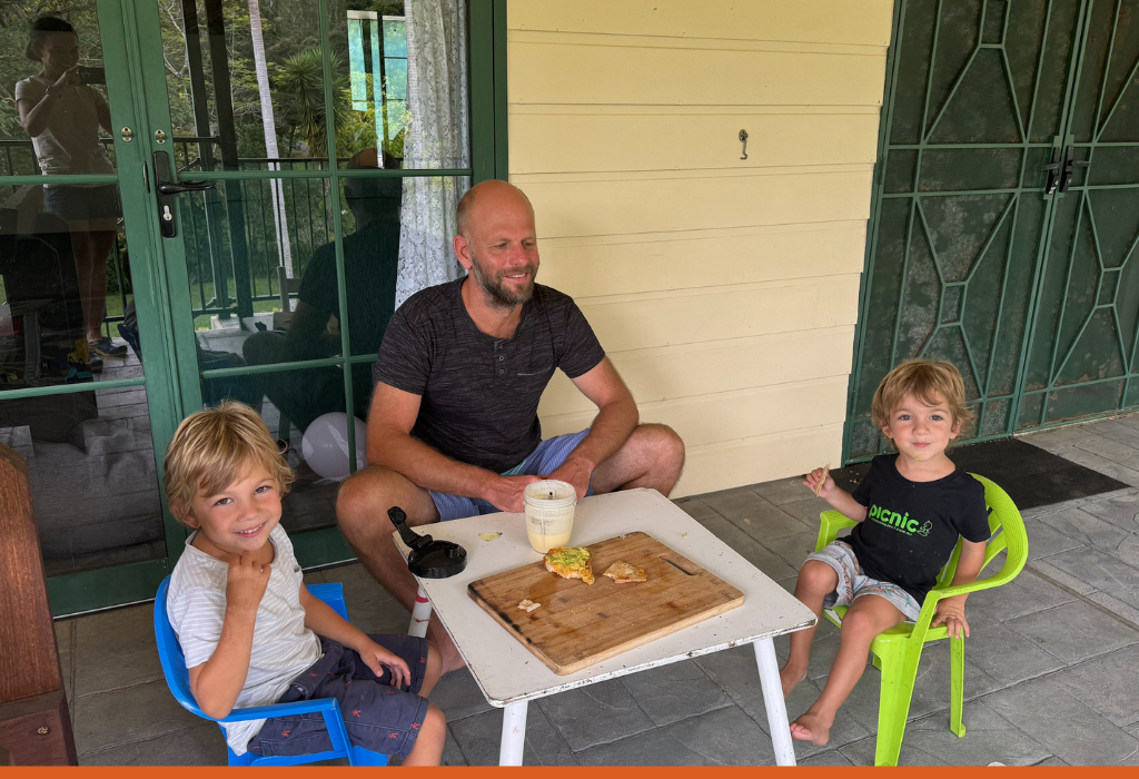 Dad eating with his 2 children.