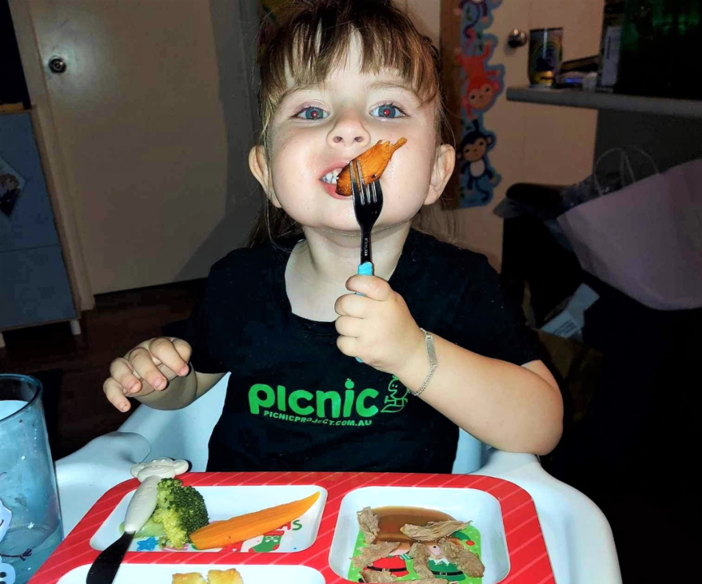 Girl eating pumpkin on folk